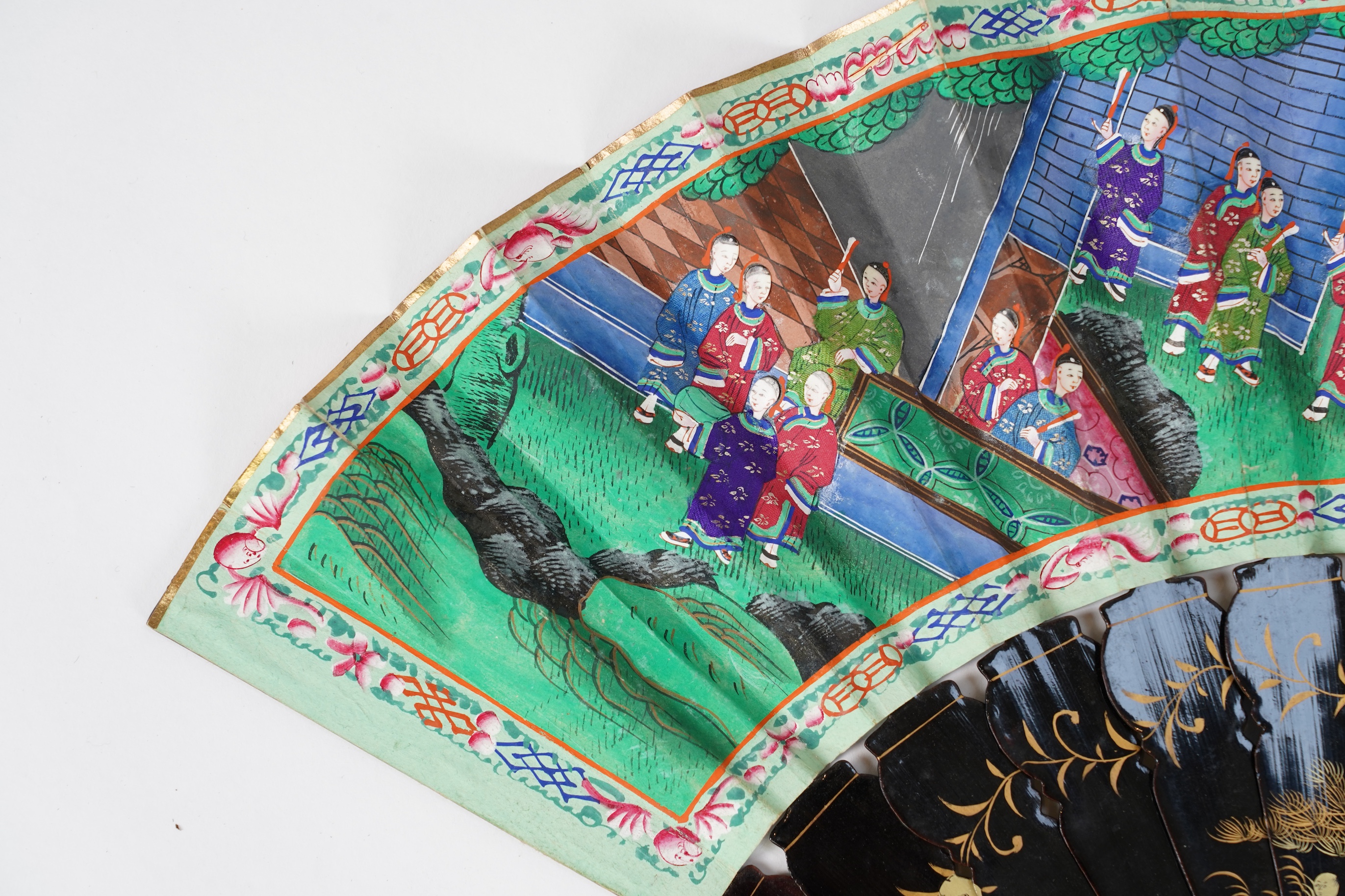 Three Chinese gilt-decorated black lacquer and painted leaf fans, 19th century